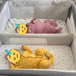 Chicco Next2Me Twins Crib review image featuring crib in testing with real babies