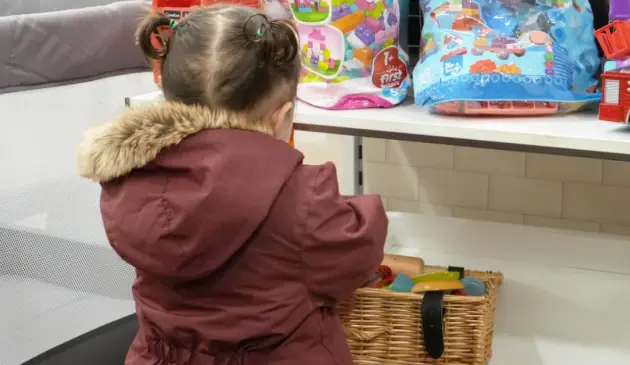 Child playing with toys at a baby bank