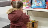 Child playing with toys at a baby bank
