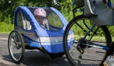 Child sitting in kids bike trailer