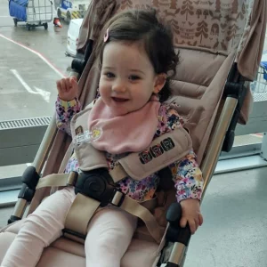 little girl sitting in Cosatto Yo