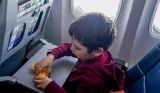 A child playing with a toy on a plane