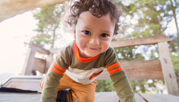 Child crawling on climbing frame