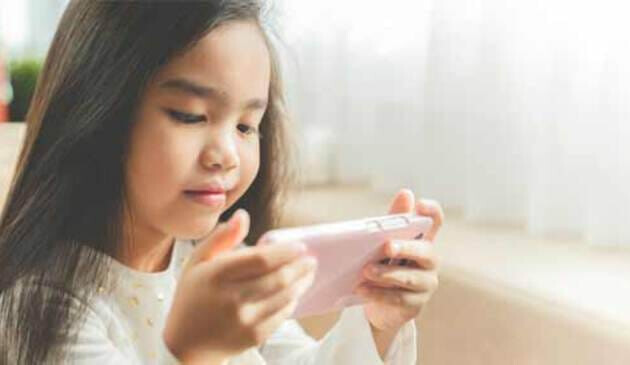 Young child playing on phone