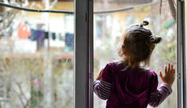 child looking out of a window
