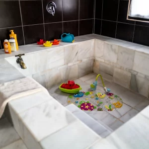 A bath filled with children's bath toys at Country Kids in the South of France