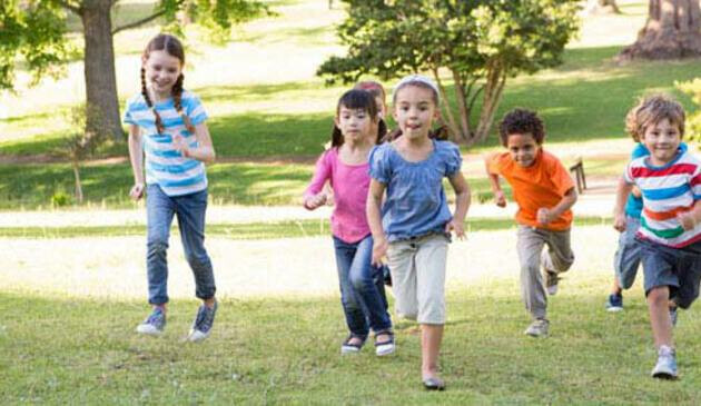 Group of children running up a hill
