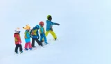 Children learning how to ski on a ski slope