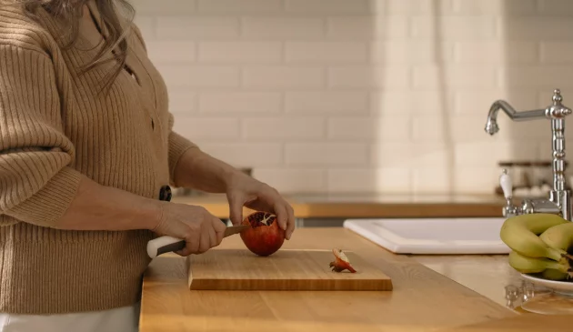 Woman using wooden chopping board