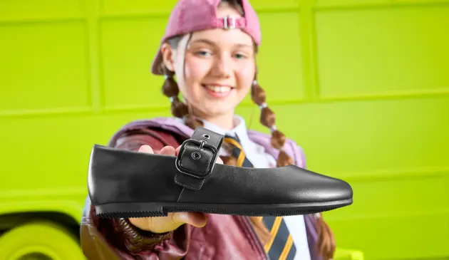 Girl holding Clarks school shoe