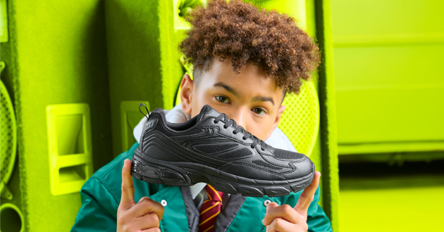 Boy holding Clarks school shoe