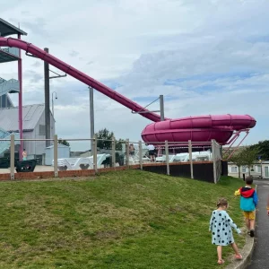 A dad and two kids walking around Combe Haven holiday park