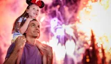 Child on dad's shoulder at Walt Disney World Resort in Florida