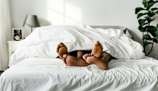 couple's feet in bed
