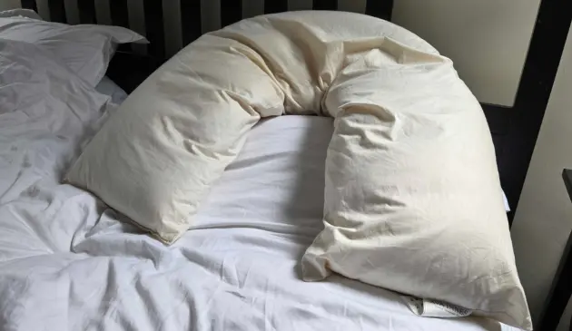 A close up of the Ava Innes V shaped pillow