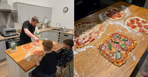 A father makes pizza with his children in a kitchen