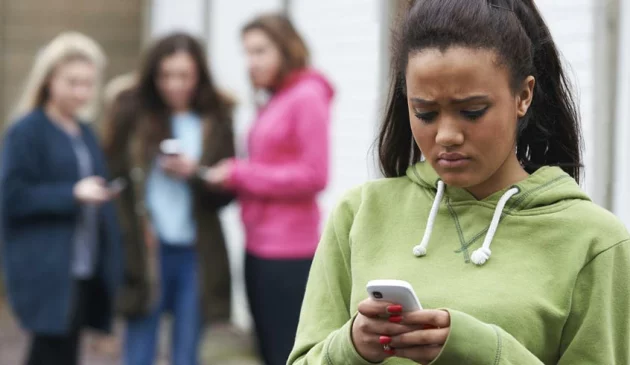sad girl looks at phone