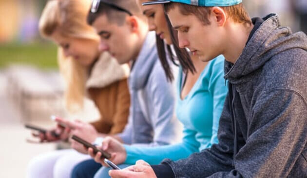 teenagers look at phones
