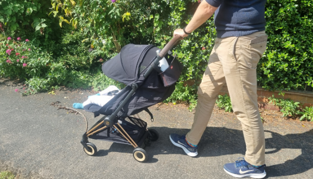 Father pushing toddler in Cybex Coya stroller