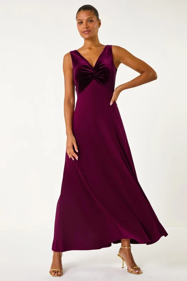 A model wears Roman's Wine Velvet Twist Front Maxi Stretch Dress