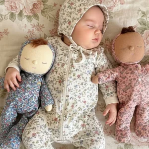 Baby hugging two Dozy Dinkum dolls