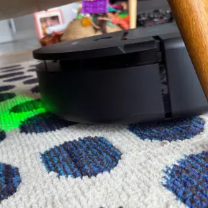 Dyson Spot + Scrub AI robot vacuum cleaner cleaning carpets