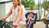 A woman and child on a bike at a Eurocamp site