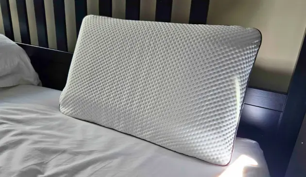 The Emma Adapt Pillow atop our tester's bed in her home
