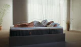 A woman sleeps on an Emma mattress