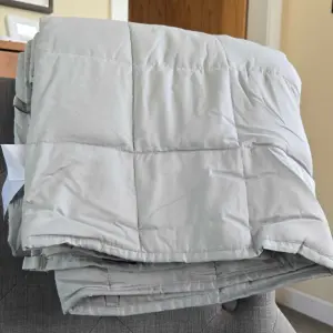 The Emma Hug Weighted Blanket in its box out of the box folder