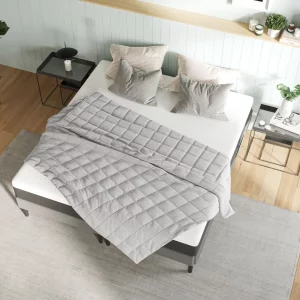 The Emma Hug Weighted Blanket from above laid out on a bed