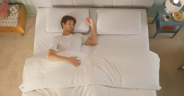 A man sleeps on the Emma Premium Foam Pillow