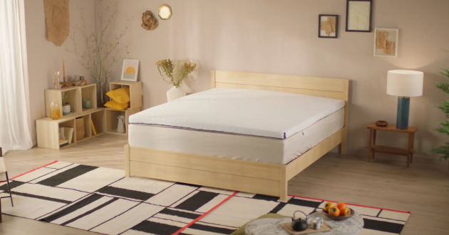 A bed has the Emma Premium Mattress Topper on