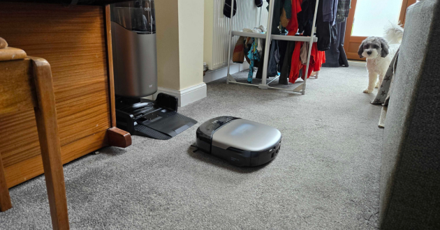 A dog watches the eufy Omni S2 robovac