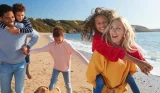 A family walking along a beach in the UK