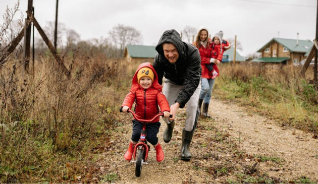 A family wearing rain coats on a caravan holiday.
