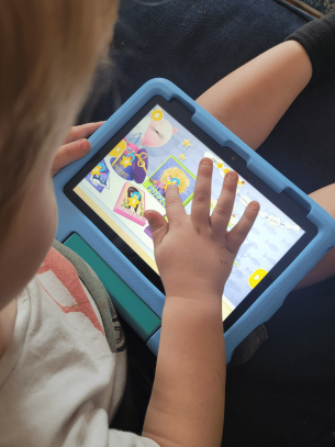 Young child testing the Amazon Fire 8 tablet