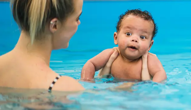 A mother and baby taking part in a Puddle Ducks swimming lesson