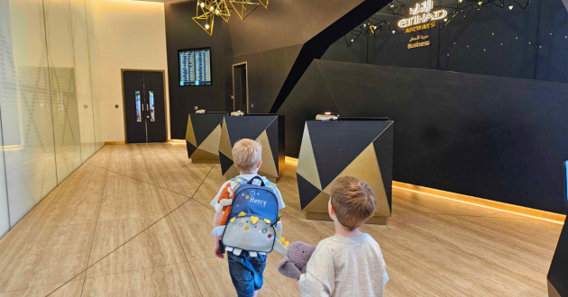 Two children walk into the Etihad airways business class lounge at Zayed International Airport in Abu Dhabi