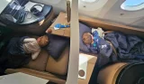 Two children sleep in their business class seats on an Etihad airways flight from Abu Dhabi