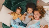 Foster mum reading with two children