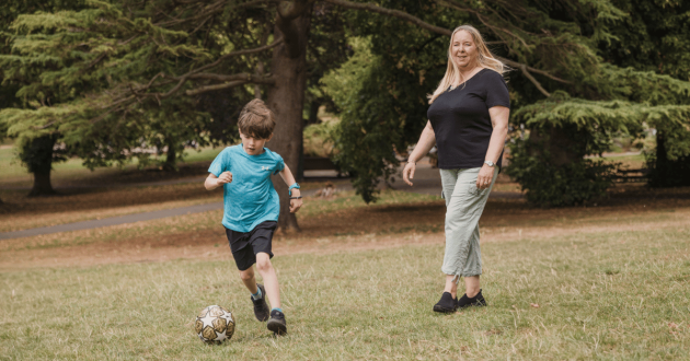 Foster mum playing football with child