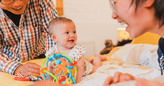 Foster parents playing with baby