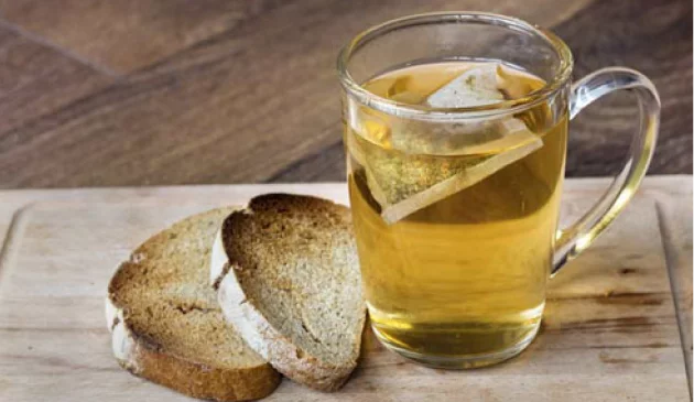 Cup of tea and toast on a wooden board