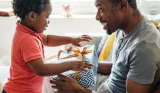 Dad giving two-year-old gift