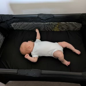 Graco FoldLite LX Travel Cot from above with newborn baby
