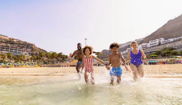 A family running in the sea in Gran Canaria