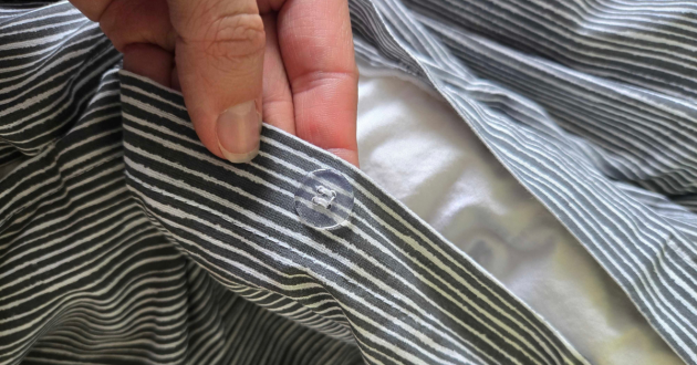 Clear button fastening on the Habitat Stockholm Stripe Grey duvet cover
