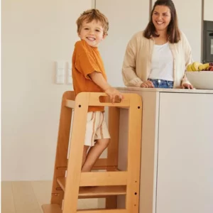 Child using Hauck Learn N Explore Montessori Learning Tower with mum in the kitchen