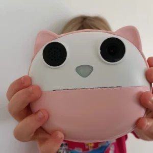 A child holding the HelloBaby Instant Print Camera